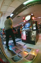 A Chinese boy plays dance blanket in arcade