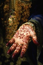 A bride`s hand patterned with henna