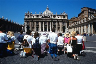 Pilgrims pray in front of St Peter`s, centre of the Roman Catholic church in Rome