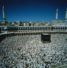 Pilgrims circumambulate the ka`aba in Mecca