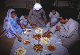 A family in Bahrain eats together at Iftar, the evening break-fast during Ramadan