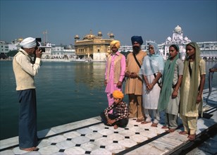 A family records their visit to the Golden Temple in Amritsar, India.