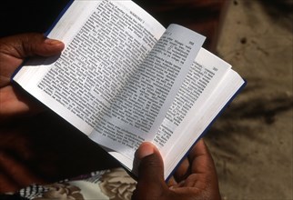 Christian in Tanzania reading the Bible in Swahili