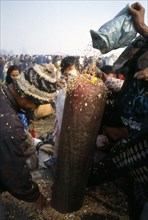 Pilgrims at Bala Chaturdashi trow offerings on lingam Kailash-Paruati, India
