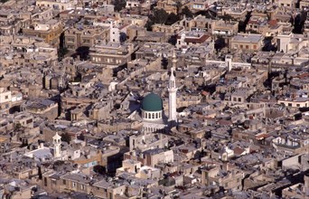 View above Damascus, Syria: roof tops, TV aerials, central green domed mosque