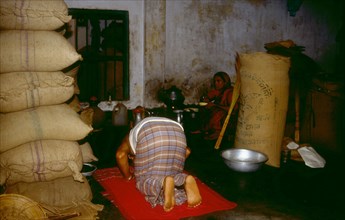 Shop merchant performing the evening prayer
