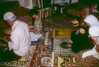 Muslim family praying at home