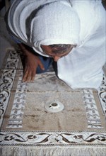 Compass pointing towards the direction of Mecca for Muslim prayers