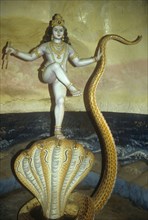 Lord Krishna dancing on the head of the serpent