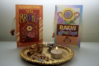 Puja tray with offerings and greeting cards on Brother`s Day Hindu Raksha Bandan