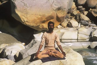 SWami practising yoga by the source of the Ganges at Gangotri India
