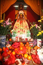 Chinese Goddess of Merchy Kuan Yin with new year offerings Hongkong