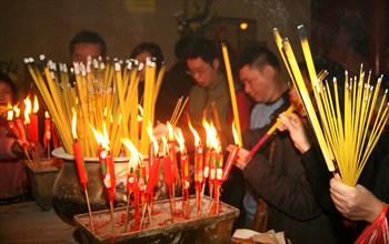 Chinese worship with burning joss sticks in a temple in Hong Kong