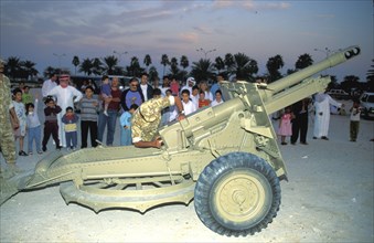 Soldier prepares to fire a cannon to signify the end
of the daily fast during Ramadan in Qatar