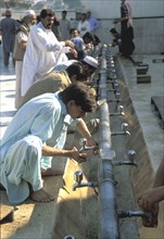 Men performing ablutions before prayers Pakistan