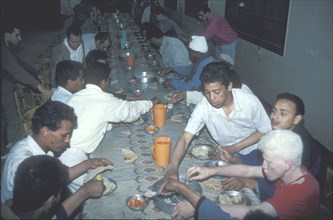 Poor street boys get a free meal during Ramadan in Cairo