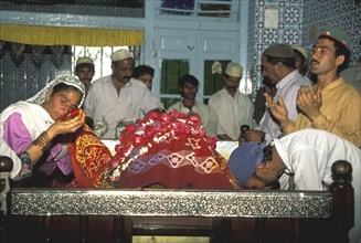 Pilgrims kissing the shroud of Abd.Shah Ghazi Muslim saint in Karachi