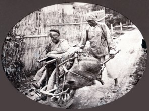 China, porter pushing a chair equipped with a wheel