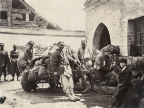 China, Peking. Photographer assistant and Chinese coolies
