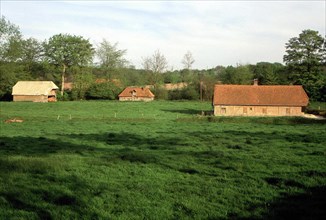 Lamberville, view from the rear of the château, towards thatched houses near the château