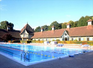 View over the west corner of the swimming pool and buildings of the Country-Club