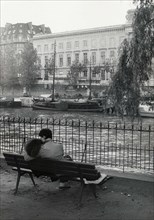 Lovers on a public bench, on the banks of the river  Seine in Paris