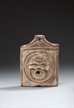 Egyptian oil lamp depicting a theatrical mask