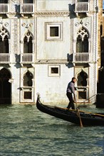 Gondolier in front of the Ca d'Oro on the Grand Canal of Venice