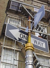 A facade in Greenwich Village and a One Way sign in New York