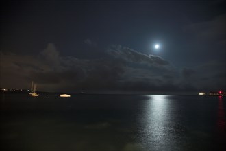 Provence356 Nuages et clair de lune la nuit sur la Méditerranée, phare rouge et voilier