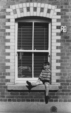 Boy in window, Ringsend, Dublin