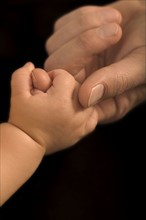 Hands of a father and his baby.