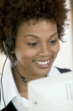 Woman wearing telephone headset.