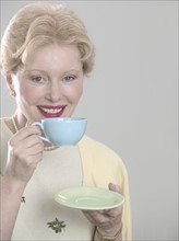 Woman with teacup and saucer.