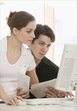 Young couple working at computer.