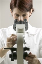 Lab technician at a microscope.