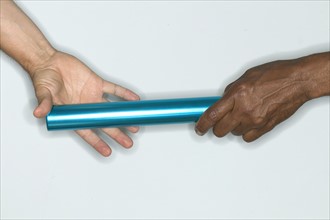 Passing baton from one hand to another.