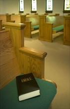 Church interior with Bible on a pew.