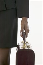 Closeup of woman holding a briefcase.