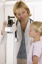 Female doctor with little girl patient.