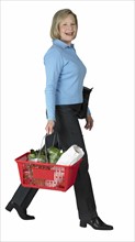 Woman carrying a shopping basket.
