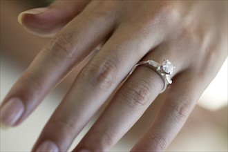 Woman's hand wearing an engagement ring.