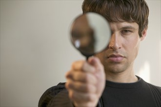 Man with magnifying glass.