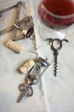 Still life of corkscrews and wine.