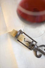 Still life of corkscrew and wine.