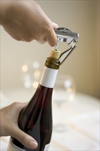Opening a bottle of wine.
