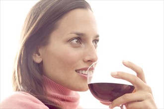 Woman holding a glass of red wine.