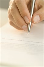 Man signing a document.