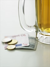 Beer mug and currency.