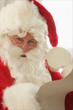Closeup of Santa checking his list.